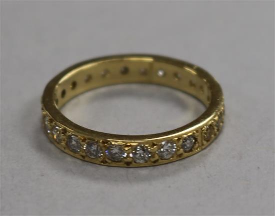 A modern 18ct gold and two colour diamond set full eternity ring, size N.
